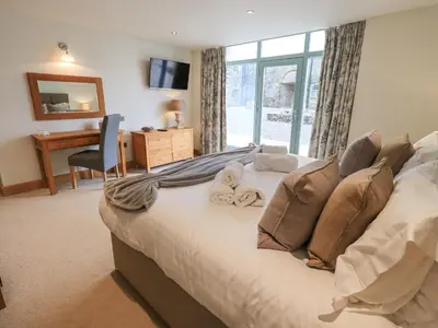 a bedroom with a bed with towels on it at Oak Cottage in Ulverston