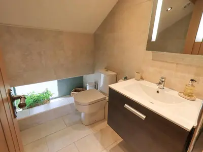 a bathroom with a toilet and a sink at Oak Cottage in Ulverston