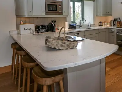 a kitchen with a counter with a basket on it at Rowan Cottage in Ulverston