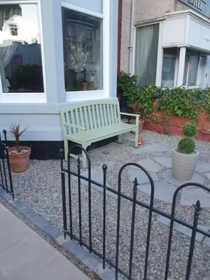 a bench sitting in front of a building at J's Mayfair Guest House in Blackpool