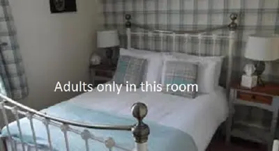 a bedroom with a bed with a poster on it at J's Mayfair Guest House in Blackpool