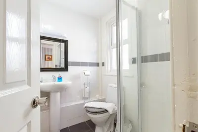 a white bathroom with a toilet and a sink at Adelaide Lodge - Town Centre - Opposite Winter Gardens in Blackpool