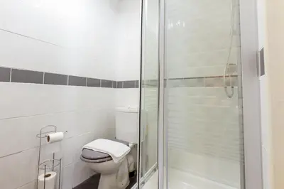 a bathroom with a toilet and a glass shower at Adelaide Lodge - Town Centre - Opposite Winter Gardens in Blackpool