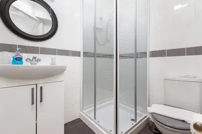 a bathroom with a shower and a toilet and a sink at Adelaide Lodge - Town Centre - Opposite Winter Gardens in Blackpool