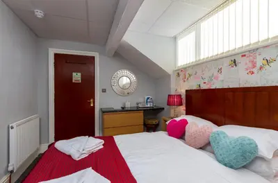 a bedroom with a bed with two hearts on it at Adelaide Lodge - Town Centre - Opposite Winter Gardens in Blackpool