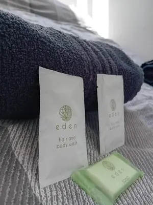 a bed with two towels on a bed with a pillow at The Merlin Hotel in Blackpool