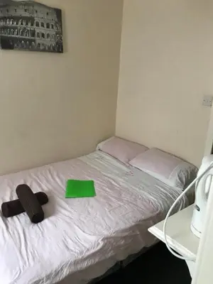 a bed with a green tray on top of it at The Merlin Hotel in Blackpool
