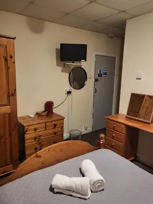 a bedroom with a bed and a tv on the wall at Talbot House in Blackpool