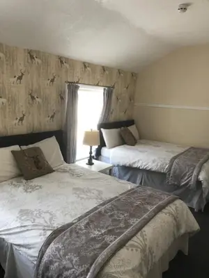 a bedroom with two beds and a window at Talbot House in Blackpool