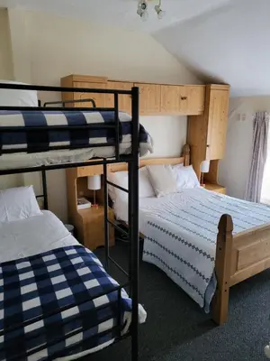 a room with two bunk beds and a bed at Talbot House in Blackpool