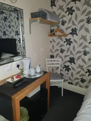 a room with a desk with a computer and a chair at Hawthorn House in Blackpool