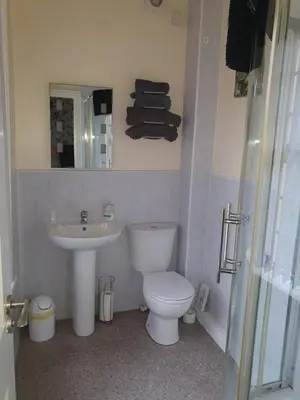 a bathroom with a white toilet and a sink at Hawthorn House in Blackpool