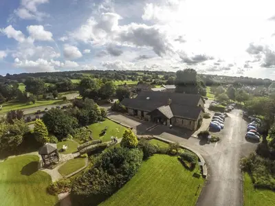 an aerial view of a house with cars parked in a driveway at Mytton Fold Hotel, Ribble Valley in Langho