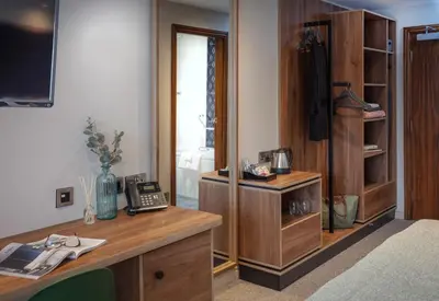 an office with a desk with a phone and a television at Mytton Fold Hotel, Ribble Valley in Langho