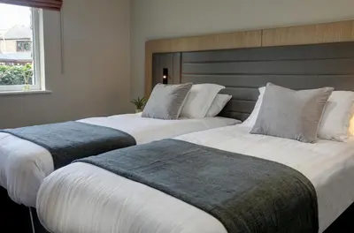 two beds sitting next to each other in a room at Mytton Fold Hotel, Ribble Valley in Langho