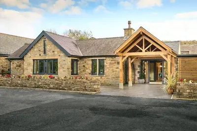 a stone house with a stone wall at Mytton Fold Hotel, Ribble Valley in Langho