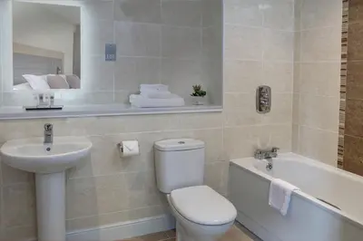 a bathroom with a toilet and a sink and a tub at Mytton Fold Hotel, Ribble Valley in Langho