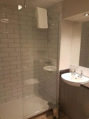 a bathroom with a shower and a sink at The Bluebird Inn at Samlesbury in Preston