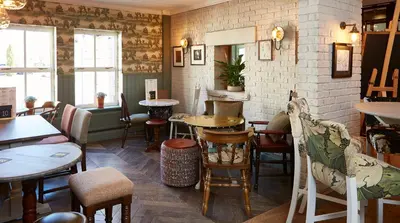 a restaurant with tables and chairs in a room at The Bluebird Inn at Samlesbury in Preston