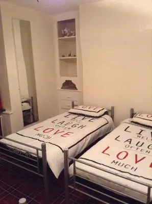 two beds with writing on them in a room at Victoria Hotel Blackpool in Blackpool