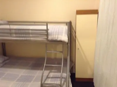 a bunk bed in a small room with a bunk bedutenewayangering at Victoria Hotel Blackpool in Blackpool