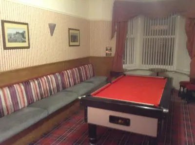 a room with a red pool table in it at Victoria Hotel Blackpool in Blackpool