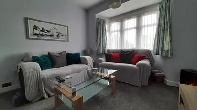a living room with a couch and a table at The Blackpool Apartment in Blackpool