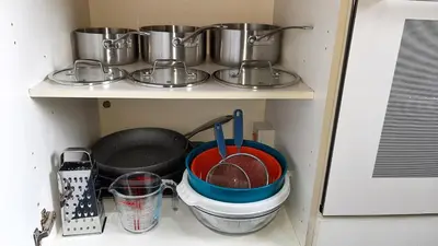 a shelf with pots and pans and utensils at The Blackpool Apartment in Blackpool
