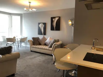 a living room with a couch and a table at Morecambe sea view apartment 203 in Morecambe