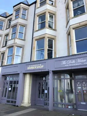 a building with the entrance to a darker shop at Morecambe sea view apartment 203 in Morecambe