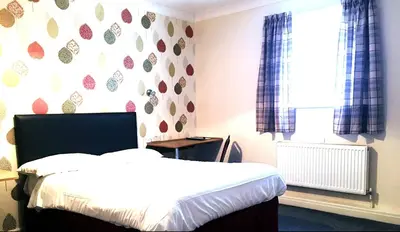 a bedroom with a bed and a window at The Mercury in Bolton