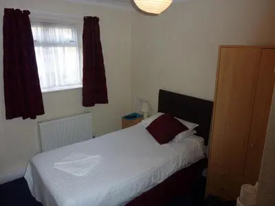 a bedroom with a bed and a window at The Mercury in Bolton