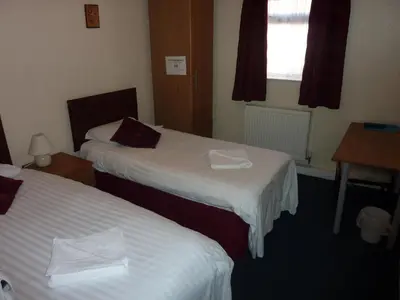 a hotel room with two beds and a window at The Mercury in Bolton