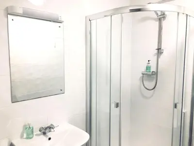 a bathroom with a shower and a sink at The Mercury in Bolton