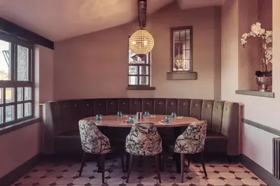 a dining room with a table and two chairs at Longlands Inn & Cottages in Carnforth