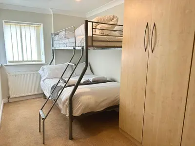 a bedroom with two bunk beds and a closet at Fabrik Apartments - Harrowside by Blackpool Service Apartements in Blackpool