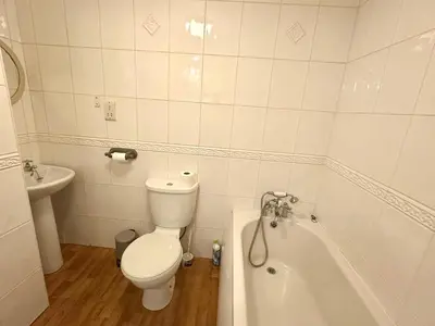 a white bathroom with a toilet and a bath tub at Fabrik Apartments - Harrowside by Blackpool Service Apartements in Blackpool