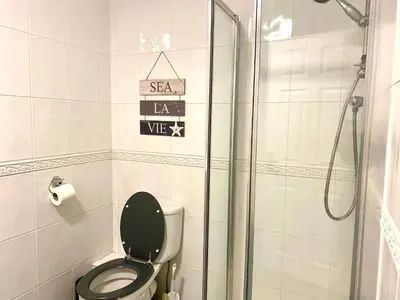 a bathroom with a toilet and a glass shower at Fabrik Apartments - Harrowside by Blackpool Service Apartements in Blackpool