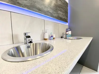 a bathroom with a stainless steel sink in a counter at Fabrik Apartments - Harrowside by Blackpool Service Apartements in Blackpool