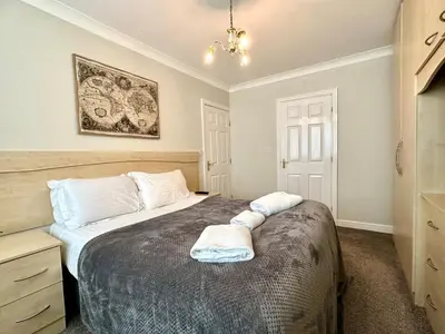 a bedroom with a bed with two towels on it at Fabrik Apartments - Harrowside by Blackpool Service Apartements in Blackpool