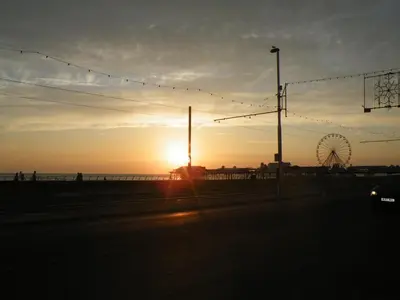 a sunset on the beach with a ferris wheel at Vinnie's Family Hotel in Blackpool