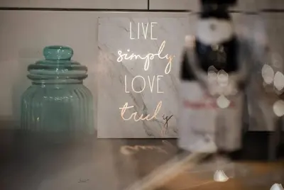 a sign that reads live simply love truly next to a glass jar at Liverpool Harrow Road Sleeps 6- Infinity Apartment in Liverpool