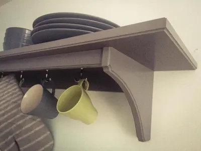 a shelf with coffee cups and plates on it at Garden Apartment in Grange Over Sands