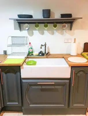 a kitchen with a sink and a counter top at Garden Apartment in Grange Over Sands