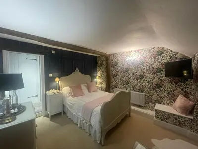 a bedroom with a bed and a tv on a wall at Low Fell in Ulverston