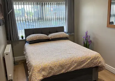 a bedroom with a large bed with a window at Chateau julie in Liverpool