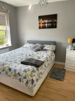 a bedroom with a bed and a painting on the wall at Chateau julie in Liverpool