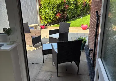 a group of chairs and a table on a patio at Chateau julie in Liverpool