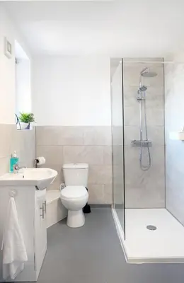 a bathroom with a shower and a toilet and a sink at The Docklands Apartment by Serviced Living Liverpool in Liverpool