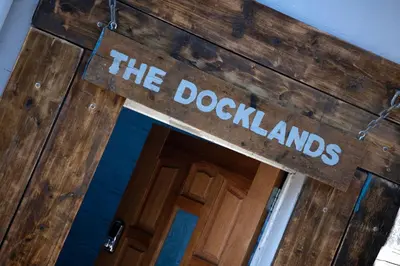 a sign that reads the doorkangs above a door at The Docklands Apartment by Serviced Living Liverpool in Liverpool